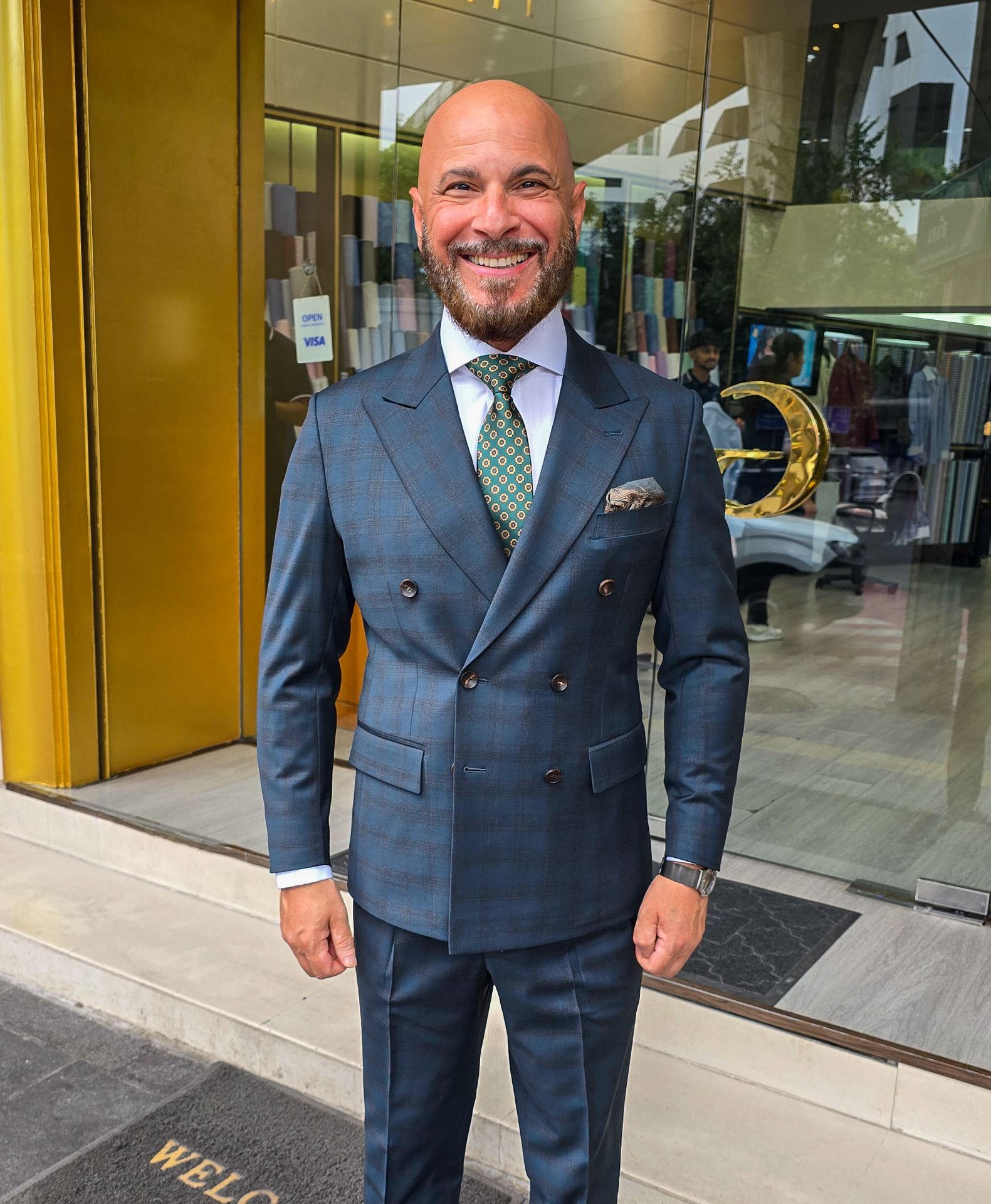 Client in a double-breasted check jacket, Bangkok showroom